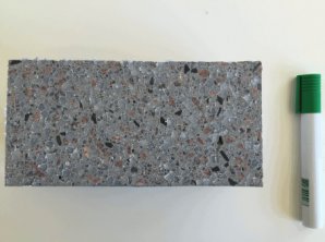 Photo of a cross-section of PE-B4C-Concrete, the marker is shown for reference.