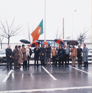 First hoisting of the Portuguese flag at CERN, following the country's membership. Photo taken on January 22 (or 23), 1986. From left to right: António Costa Lobo (Portugal's ambassador to the UN in Geneva), Gaspar Barreira (who would be director of LIP for many years), Karin Wall (José Mariano Gago's wife), José Mariano Gago (Founder and President of LIP, and later Portuguese Minister of Science and Technology, deceased in 2015), Catarina Wall Gago (his baby daughter), João Varela (who would become vice-spokesperson of the CMS collaboration at the LHC), Herwig Schopper (CERN's Director-General), Eduardo Arantes e Oliveira (Portugal's Secretary of State for Science), <man hoisting flag>, Margarida Nesbitt Rebelo, <man>, Mário Pimenta (today, president of LIP), <man>, Gustavo Castelo Branco, João Seixas, Sérgio Ramos, and Peter Sonderegger.